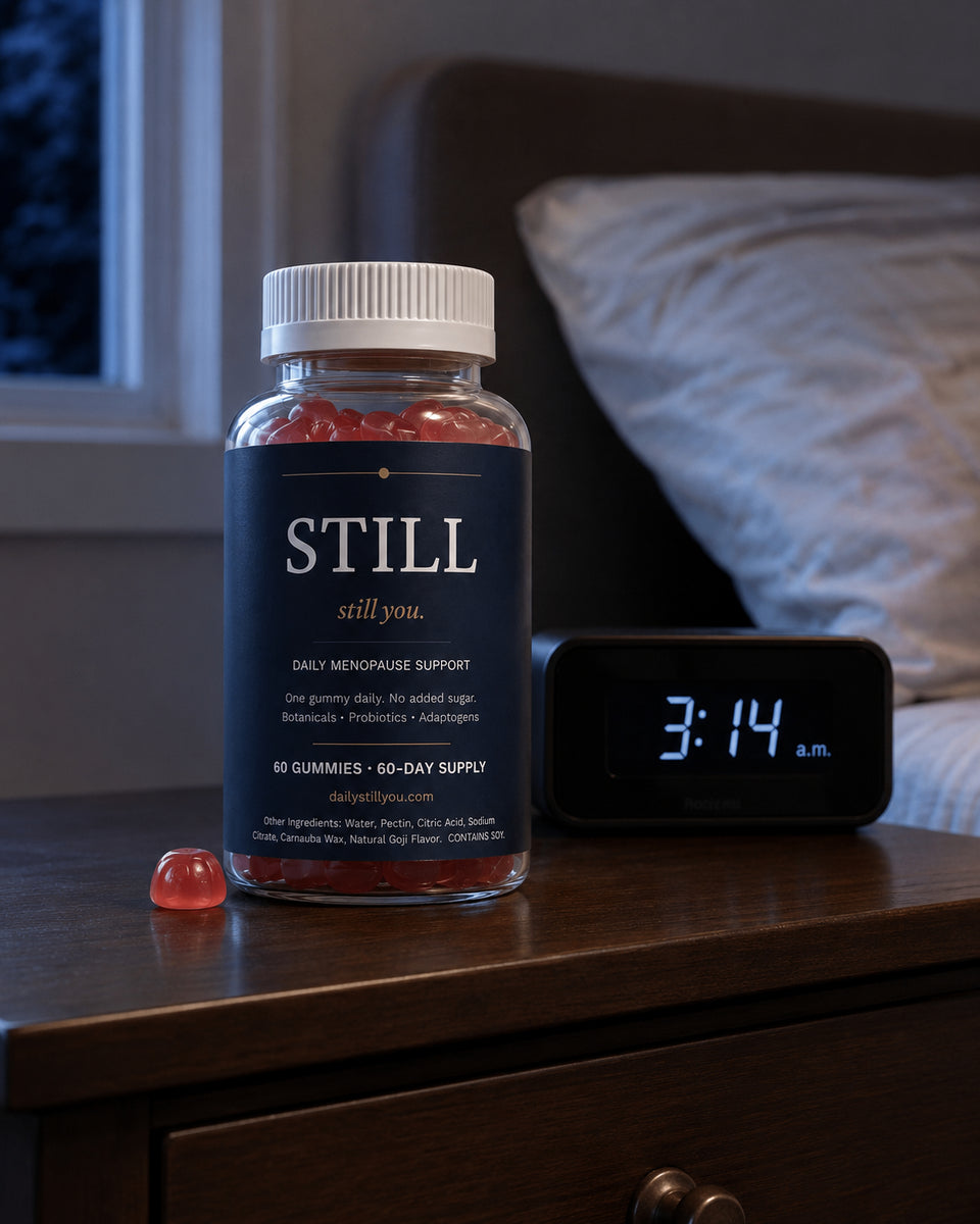 Still You bottle on a bedside table beside an alarm clock reading 3:14 a.m.