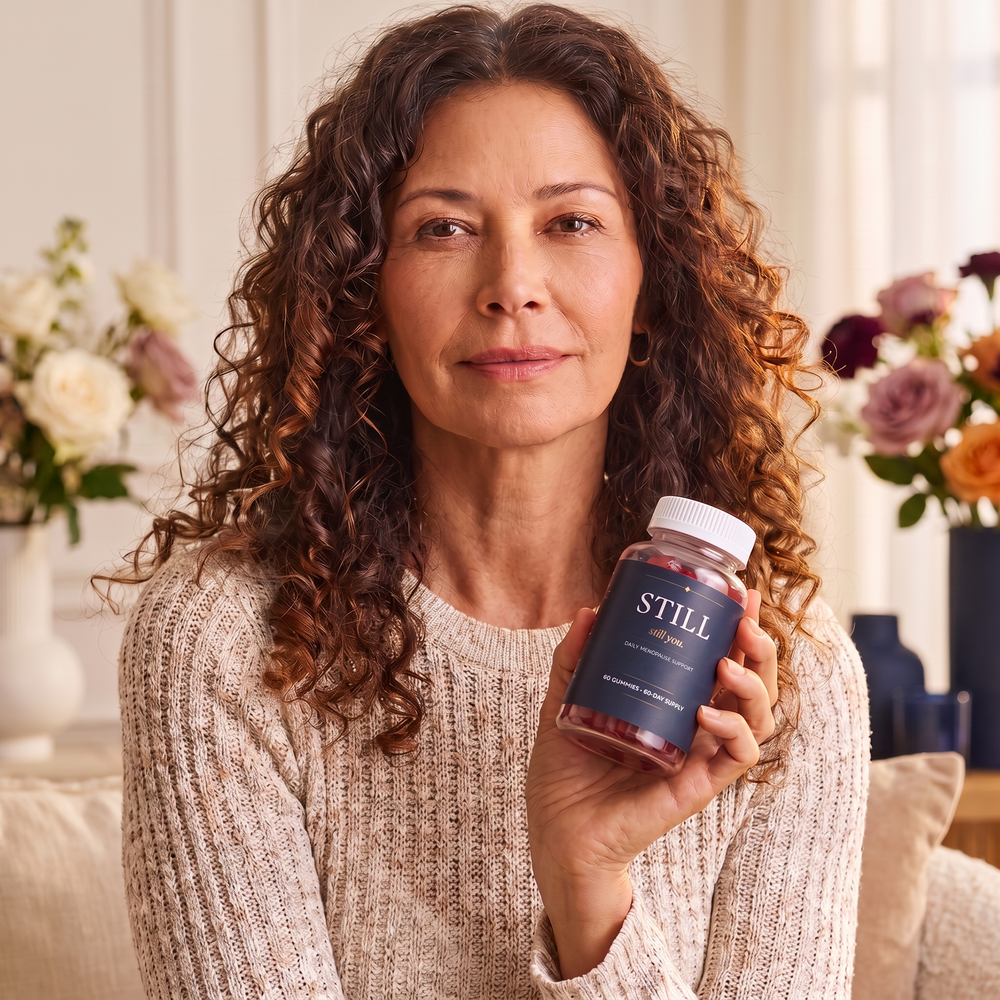 Woman holding a bottle of Still You Peri Night Gummies